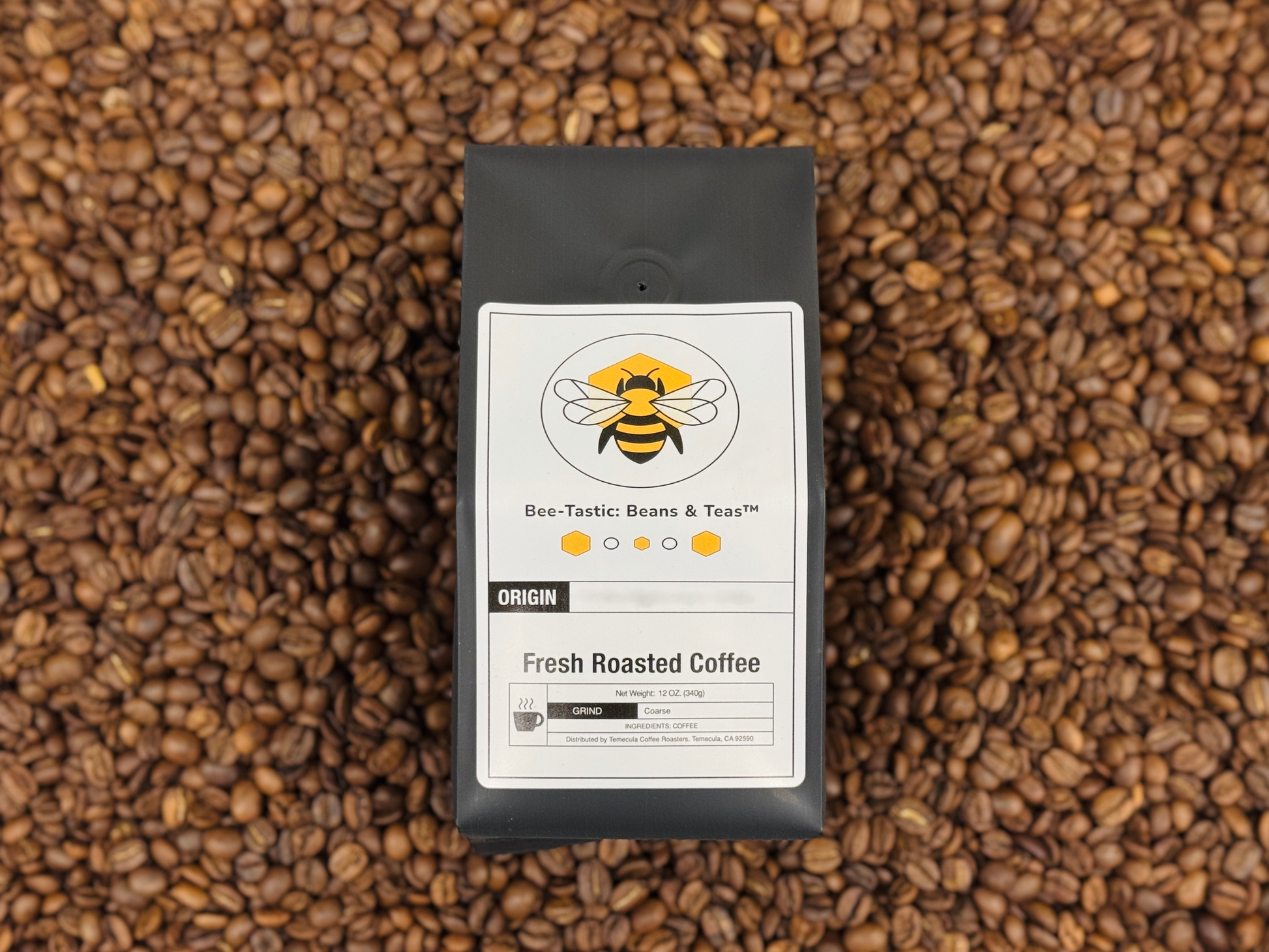 Bee-Tastic: Beans & Teas™ bag sitting on top of a pile of coffee beans.