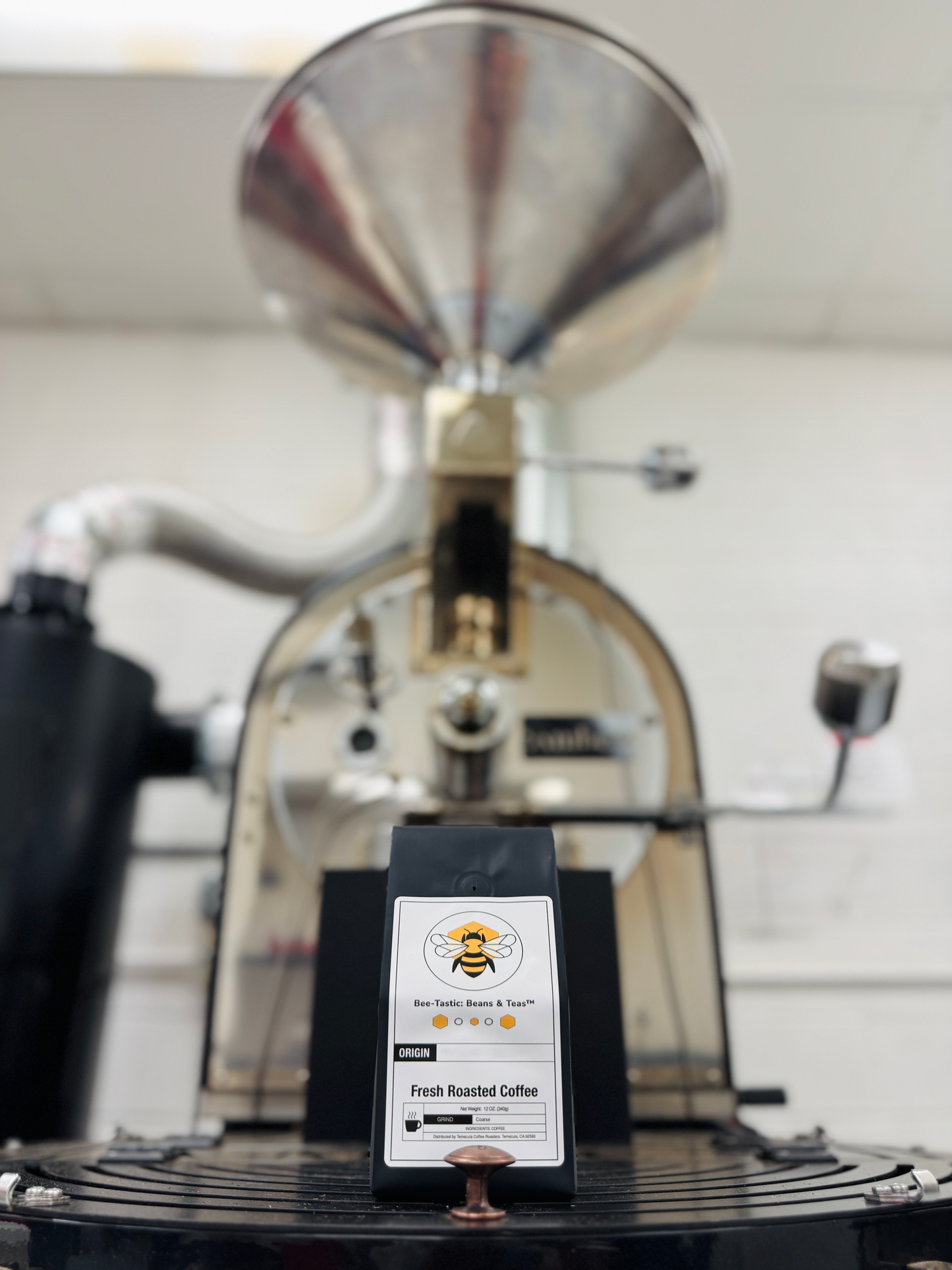 Bee-Tastic: Beans & Teas™ bag sitting on top of a roaster